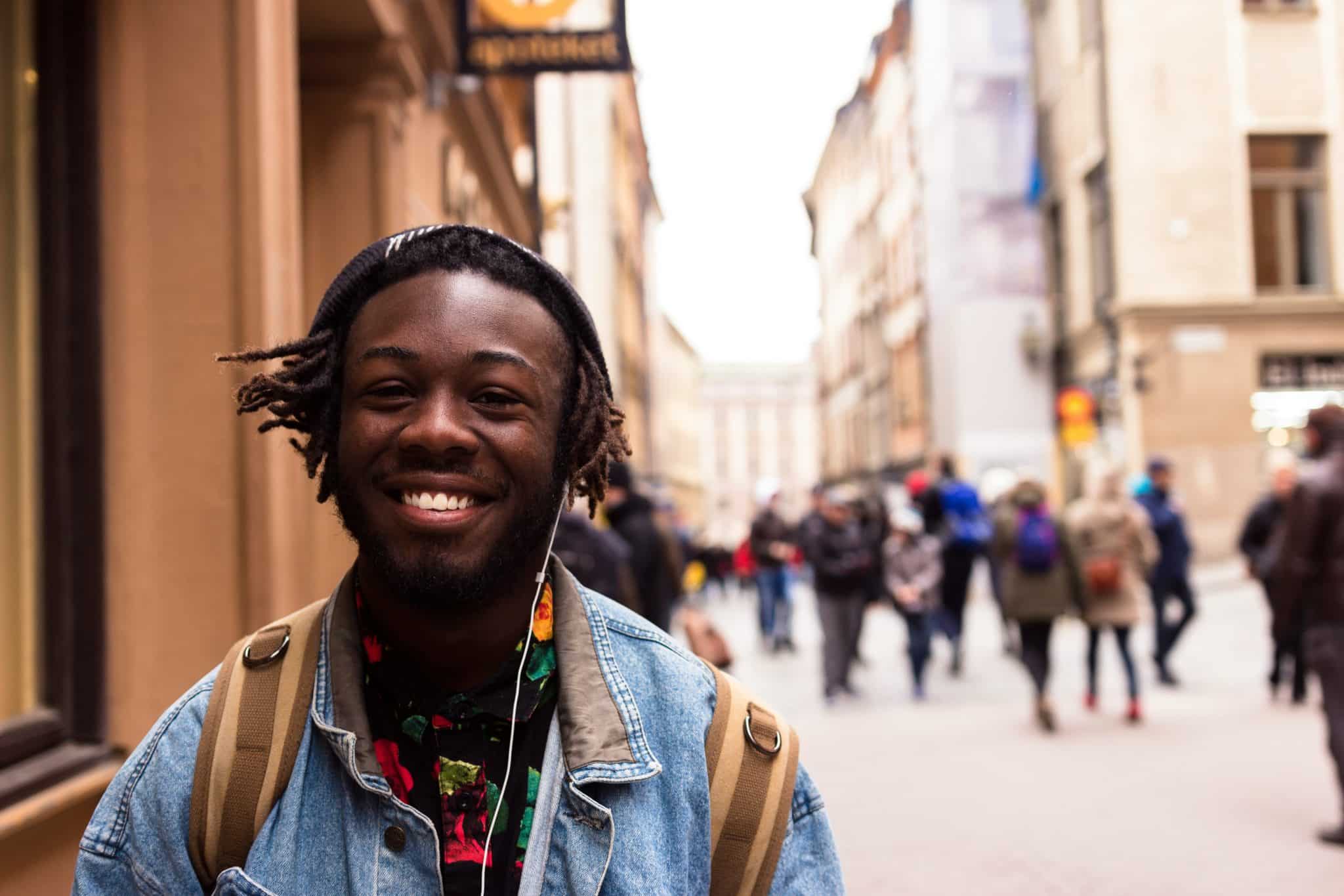 Black man smiling on the street in Stockholm